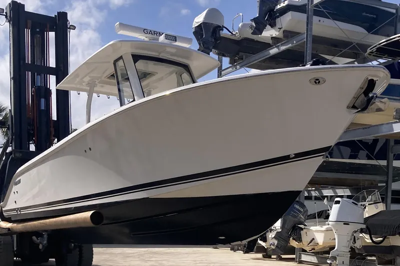No Jet Lag Yacht Photos Pics 2019 Pursuit S 288 Sport boat on forklift, marina background.