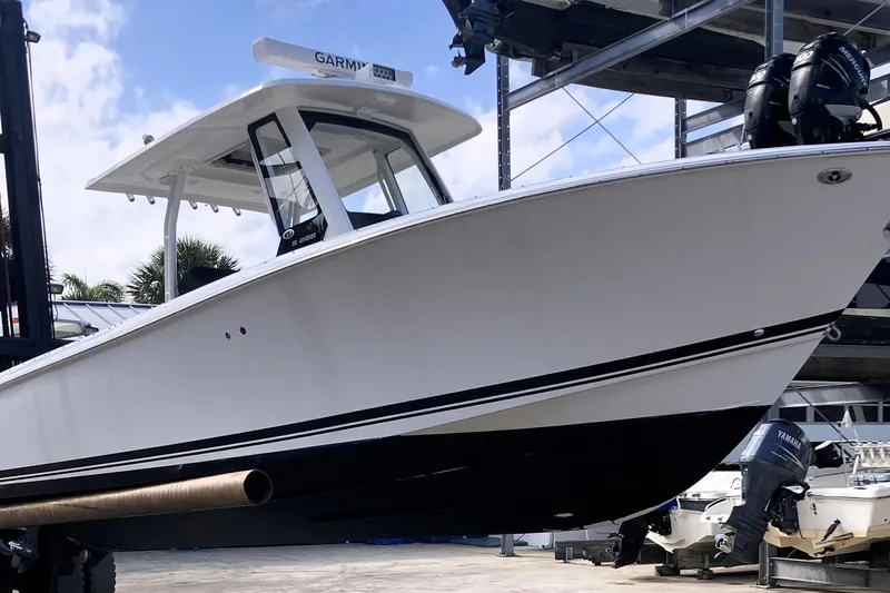 No Jet Lag Yacht Photos Pics 2019 Pursuit S 288 Sport boat on lift, featuring sleek design and dual engines.