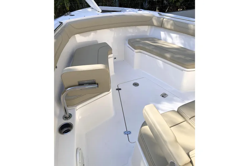 No Jet Lag Yacht Photos Pics 2019 Pursuit S 288 Sport boat interior with beige seating and stainless steel accents.