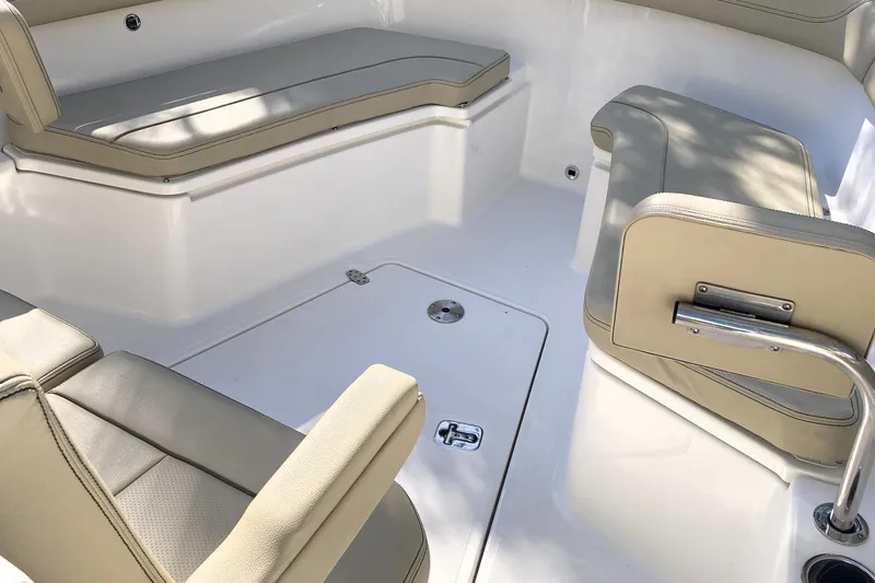 No Jet Lag Yacht Photos Pics 2019 Pursuit S 288 Sport boat interior with beige cushioned seating and white deck.