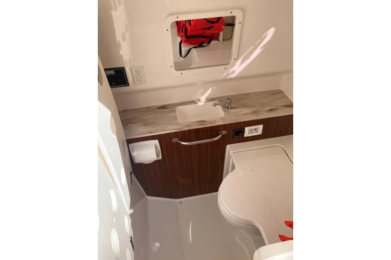 No Jet Lag Yacht Photos Pics 2019 Pursuit S 288 Sport boat interior with sink, mirror, and storage.