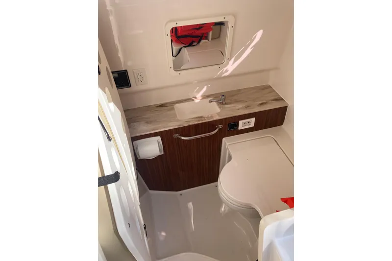 No Jet Lag Yacht Photos Pics 2019 Pursuit S 288 Sport boat interior with sink and storage.