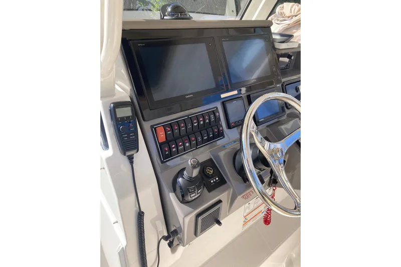 No Jet Lag Yacht Photos Pics 2019 Pursuit S 288 Sport boat dashboard with dual screens and controls.