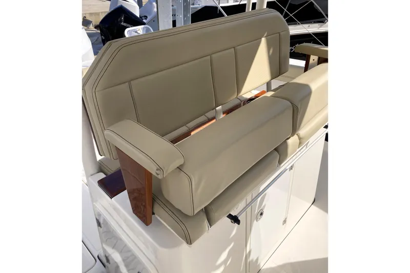 No Jet Lag Yacht Photos Pics 2019 Pursuit S 288 Sport boat seat with beige upholstery and wooden accents.