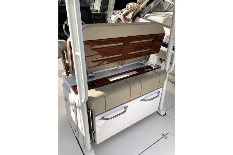 No Jet Lag Yacht Photos Pics 2019 Pursuit S 288 Sport boat interior with beige seating and wood accents.