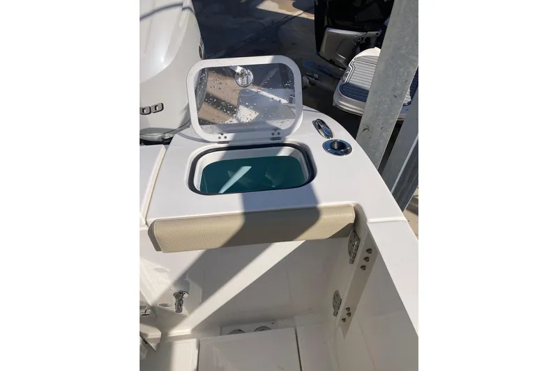 No Jet Lag Yacht Photos Pics 2019 Pursuit S 288 Sport boat with open storage compartment and cup holder.