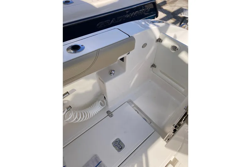 No Jet Lag Yacht Photos Pics 2019 Pursuit S 288 Sport boat interior with storage compartment and coiled hose.