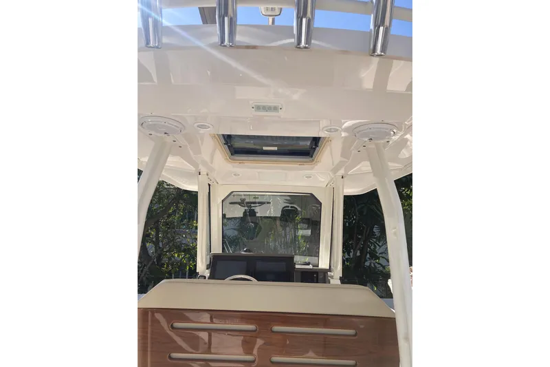 No Jet Lag Yacht Photos Pics 2019 Pursuit S 288 Sport boat interior with helm and overhead rod holders.