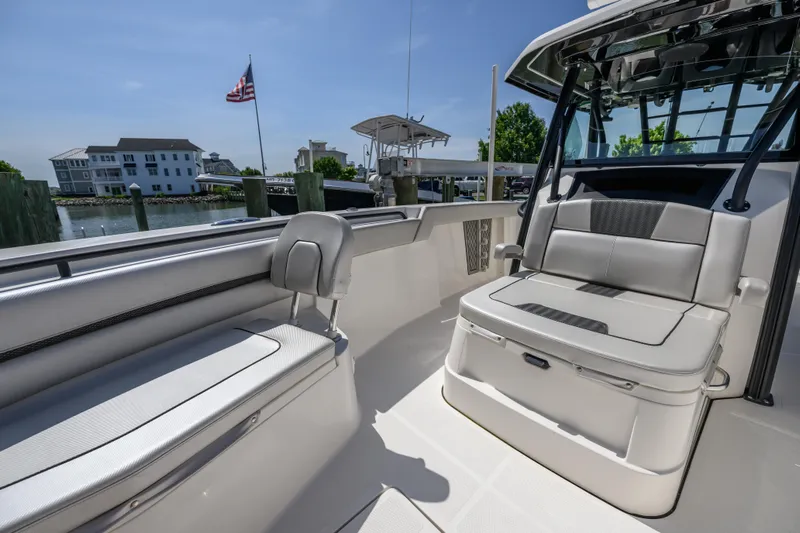 Jokers Jewel Yacht Photos Pics 2019 Wellcraft 352 Fisherman boat interior with seating, docked near waterfront homes.