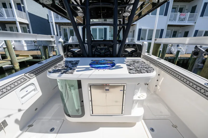 Jokers Jewel Yacht Photos Pics 2019 Wellcraft 352 Fisherman boat interior with fishing station and storage, docked near waterfront homes.