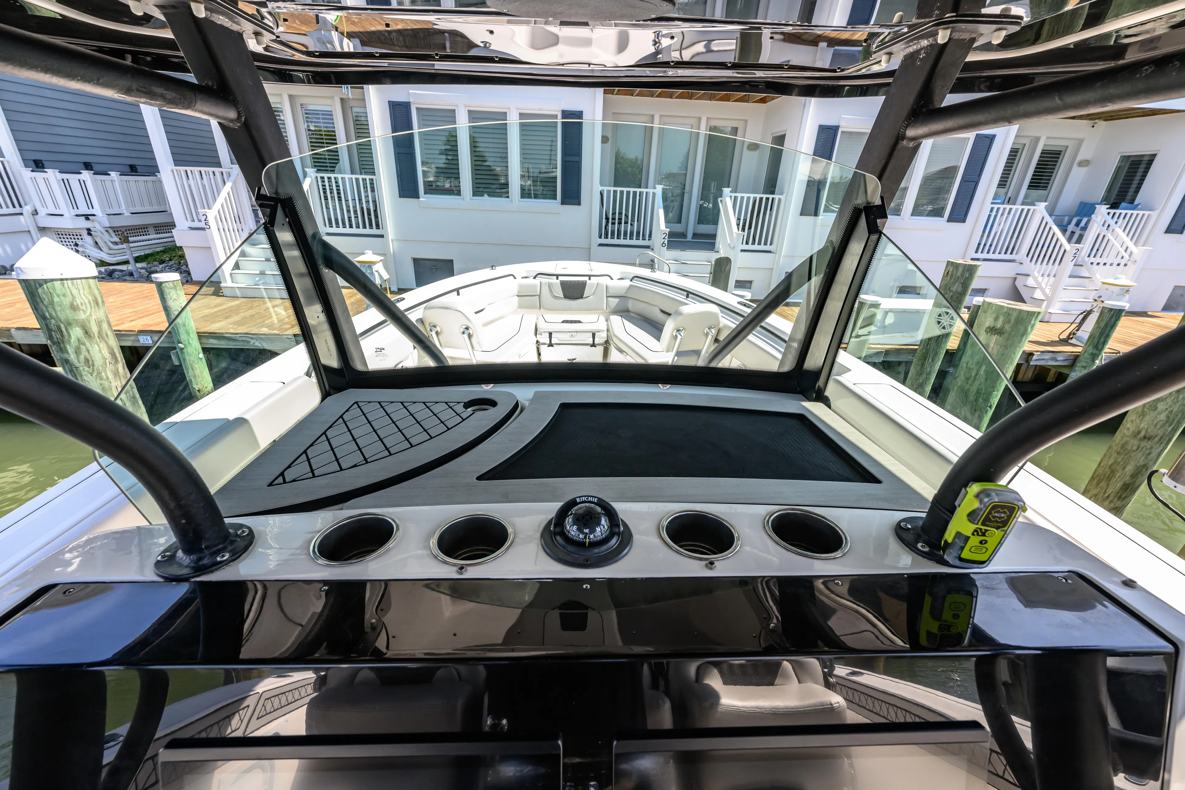 Jokers Jewel Yacht Photos Pics 2019 Wellcraft 352 Fisherman boat dashboard with cup holders and waterfront view.