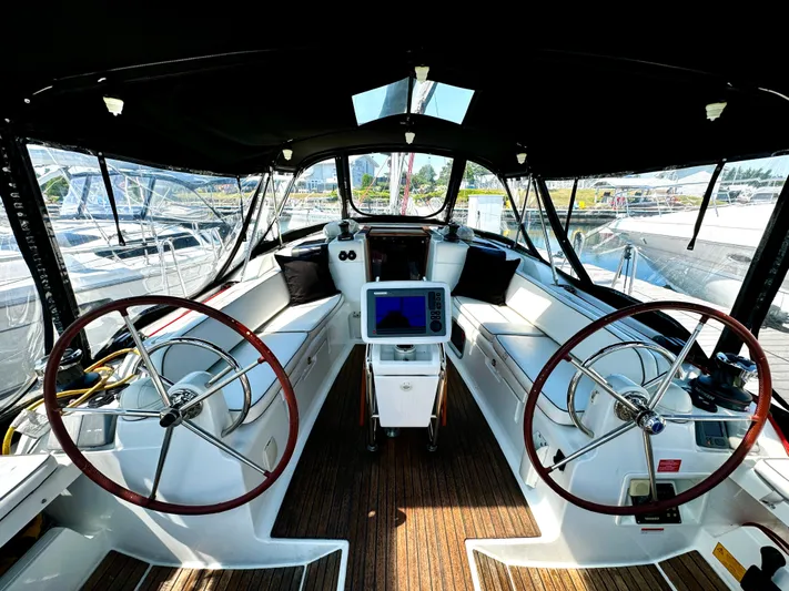  Yacht Photos Pics Cockpit of 2011 Jeanneau Sun Odyssey 409 sailboat with dual steering wheels and navigation equipment.