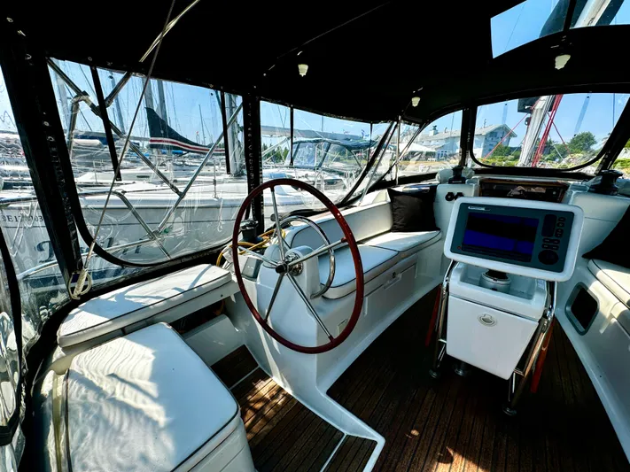  Yacht Photos Pics Interior of 2011 Jeanneau Sun Odyssey 409 sailboat cockpit with steering wheel and navigation equipment.
