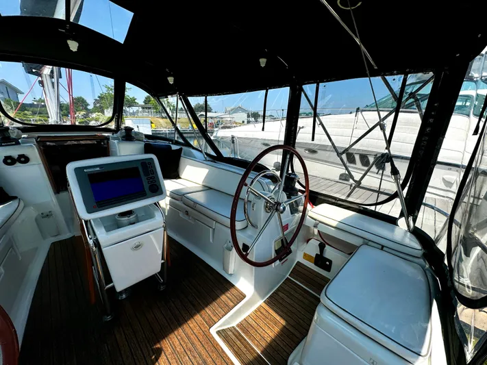  Yacht Photos Pics Interior view of 2011 Jeanneau Sun Odyssey 409 sailboat cockpit with navigation equipment.
