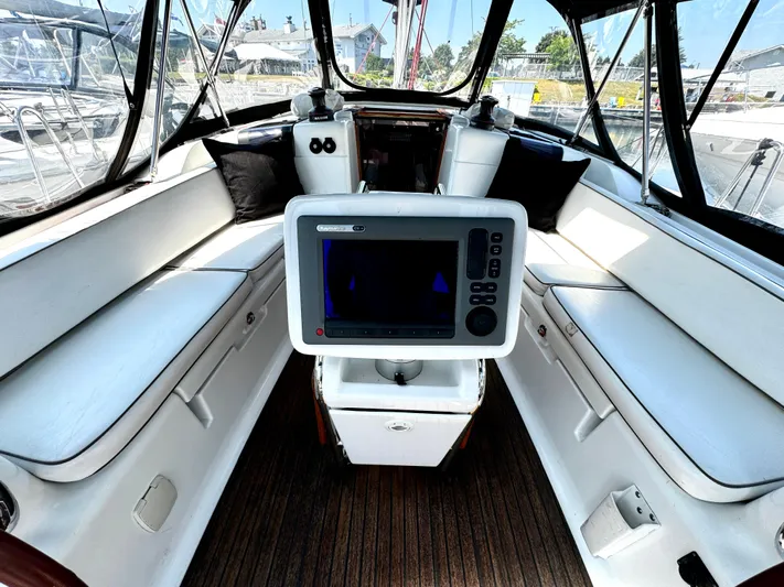  Yacht Photos Pics Interior view of 2011 Jeanneau Sun Odyssey 409 sailboat cockpit with navigation equipment.