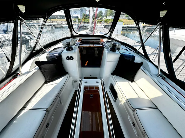  Yacht Photos Pics Cockpit of 2011 Jeanneau Sun Odyssey 409 sailboat with cushioned seating and sleek design.