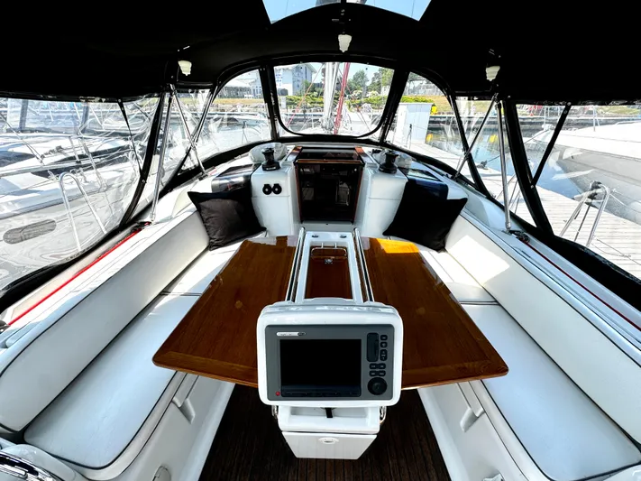  Yacht Photos Pics Cockpit of 2011 Jeanneau Sun Odyssey 409 sailboat with seating and navigation equipment.