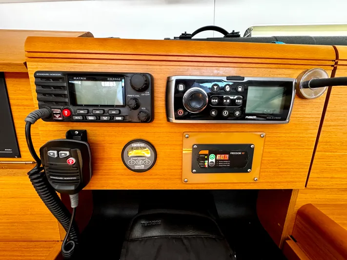  Yacht Photos Pics Control panel of a 2011 Jeanneau Sun Odyssey 409 sailboat with radio and navigation equipment.
