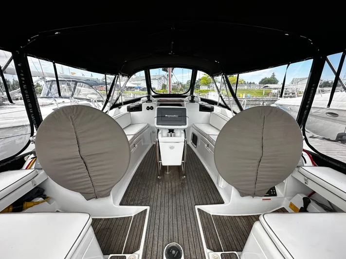  Yacht Photos Pics Interior view of 2011 Jeanneau Sun Odyssey 409 sailboat cockpit with covered steering wheels.