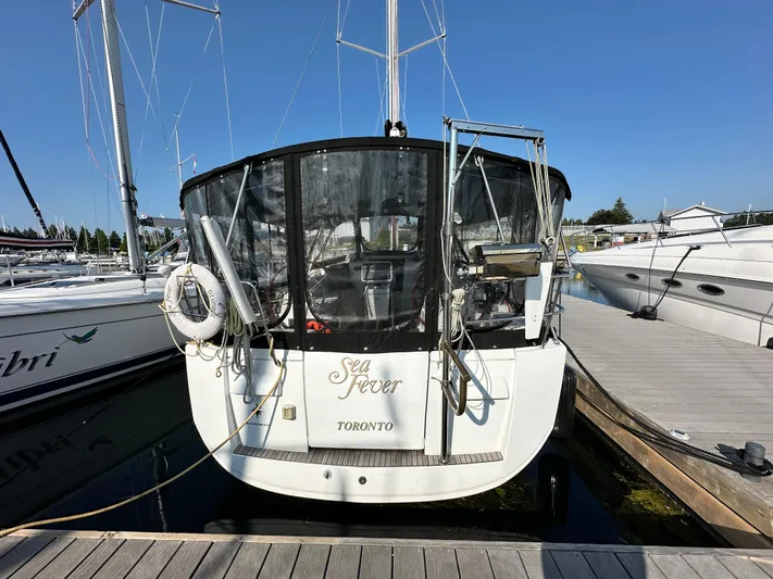  Yacht Photos Pics Jeanneau Sun Odyssey 409 sailboat docked, rear view, with "Sea Fever" and "Toronto" on the stern.