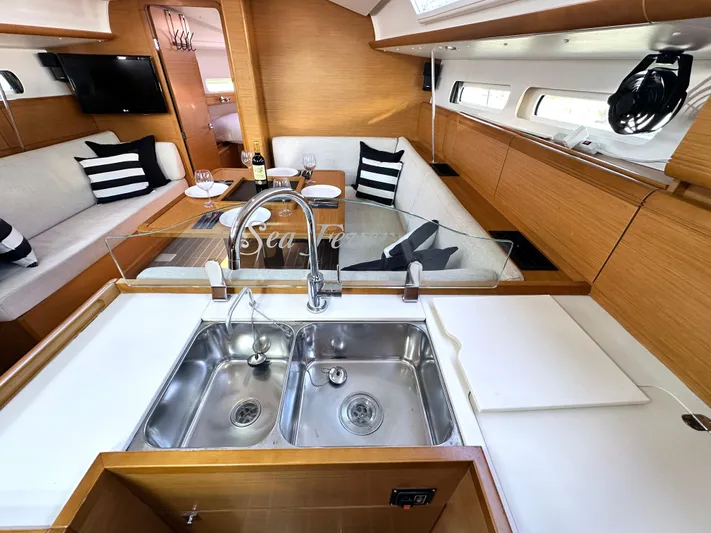  Yacht Photos Pics Interior of 2011 Jeanneau Sun Odyssey 409 yacht with modern kitchen and cozy seating area.