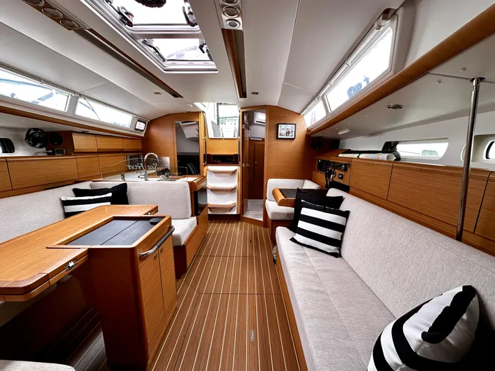  Yacht Photos Pics Luxurious interior of 2011 Jeanneau Sun Odyssey 409 sailboat with modern wood finish.