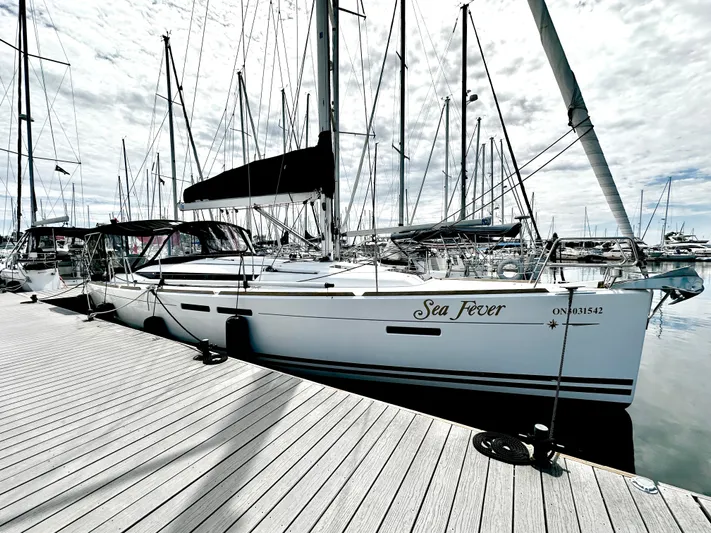  Yacht Photos Pics 2011 Jeanneau Sun Odyssey 409 sailboat docked at marina under cloudy sky.