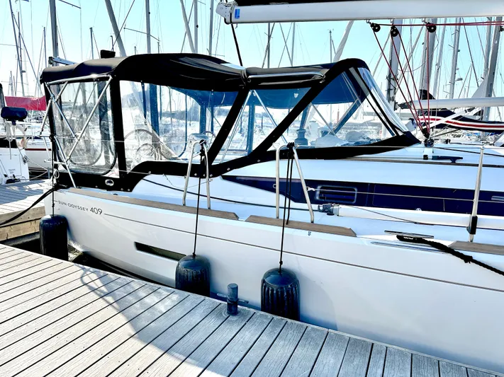  Yacht Photos Pics Jeanneau Sun Odyssey 409 sailboat docked, 2011 model, with protective canopy and fenders.