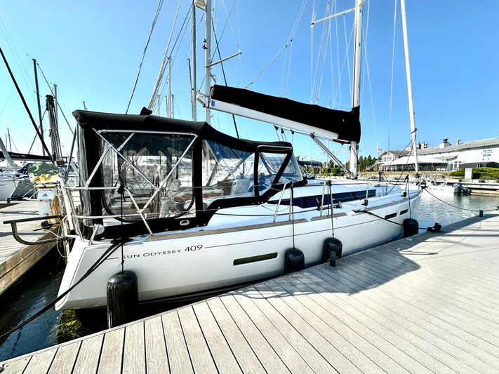  Yacht Photos Pics 2011 Jeanneau Sun Odyssey 409 sailboat docked at marina under clear blue sky.