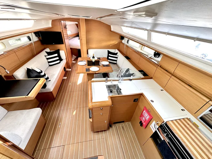  Yacht Photos Pics Interior of 2011 Jeanneau Sun Odyssey 409 yacht with modern kitchen and cozy seating area.