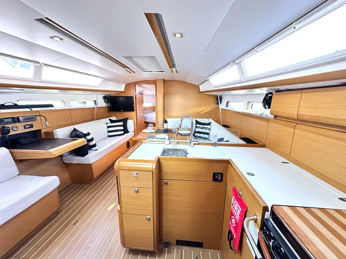  Yacht Photos Pics Interior of 2011 Jeanneau Sun Odyssey 409 yacht, featuring modern kitchen and seating area.