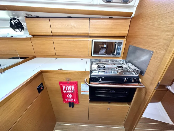  Yacht Photos Pics Modern kitchen in 2011 Jeanneau Sun Odyssey 409 yacht with stove, microwave, and fire blanket.