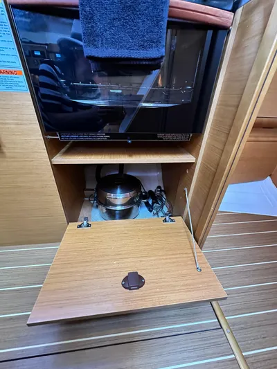  Yacht Photos Pics Interior of 2011 Jeanneau Sun Odyssey 409 showing a compact kitchen area with appliances.