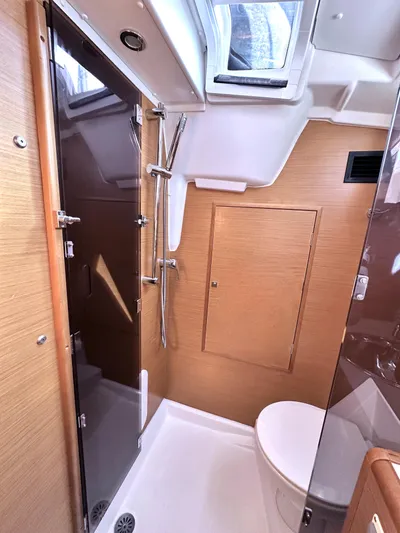  Yacht Photos Pics Bathroom interior of 2011 Jeanneau Sun Odyssey 409 yacht, featuring shower and toilet.
