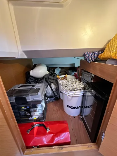  Yacht Photos Pics Storage area in a 2011 Jeanneau Sun Odyssey 409 yacht with various equipment and supplies.