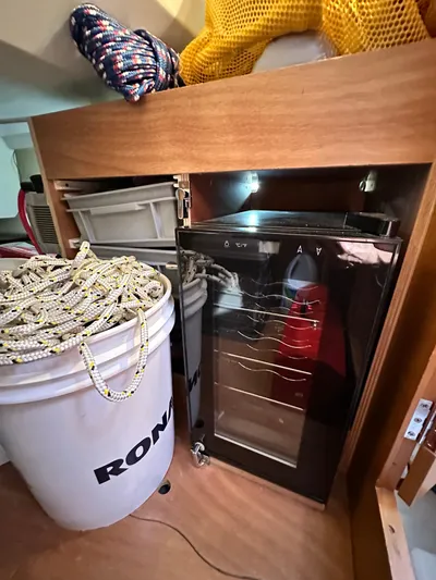  Yacht Photos Pics Storage area on a 2011 Jeanneau Sun Odyssey 409 with ropes and a small fridge.