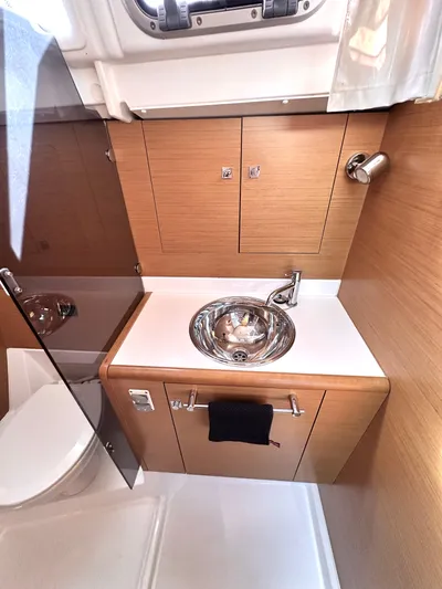  Yacht Photos Pics 2011 Jeanneau Sun Odyssey 409 bathroom with modern sink and wooden cabinetry.