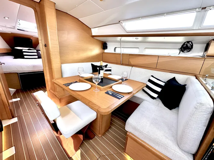  Yacht Photos Pics Interior of 2011 Jeanneau Sun Odyssey 409 yacht with elegant dining area and cozy seating.