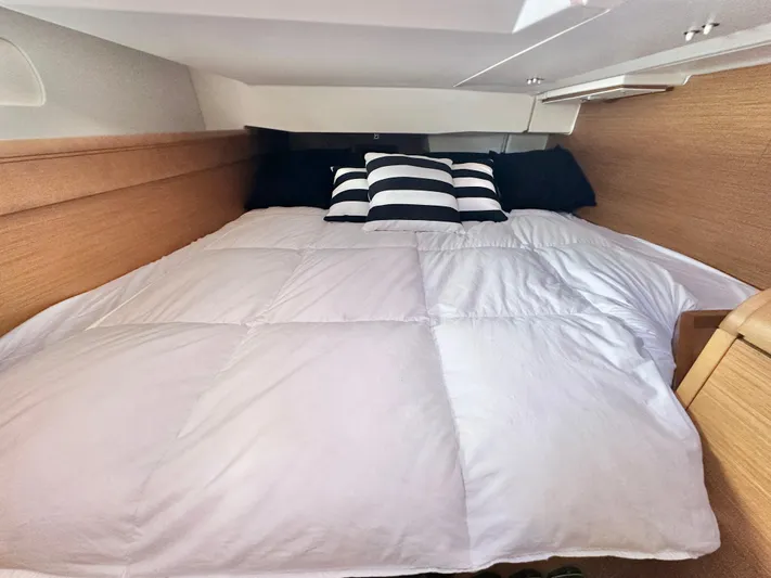  Yacht Photos Pics Cozy cabin bed in 2011 Jeanneau Sun Odyssey 409 yacht with striped pillows.