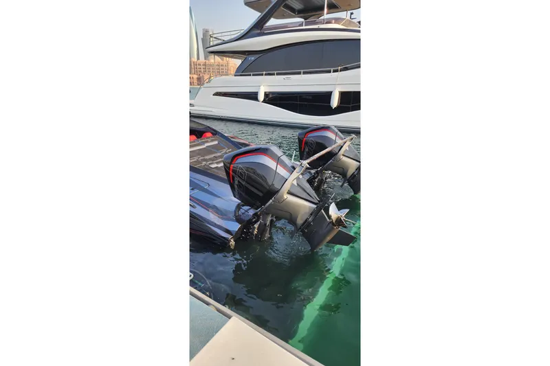  Yacht Photos Pics 2025 MTI 440X boat with dual engines docked beside a luxury yacht.