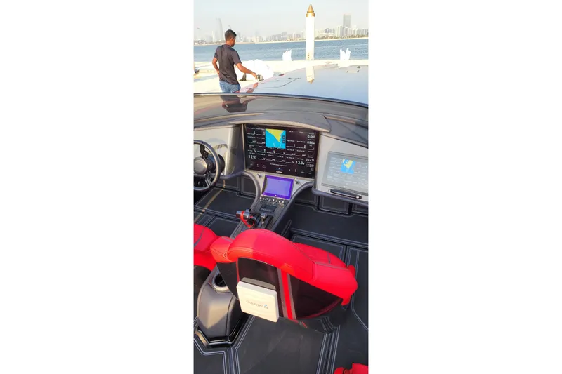  Yacht Photos Pics Interior of 2025 MTI 440X boat with advanced navigation displays and red seating.