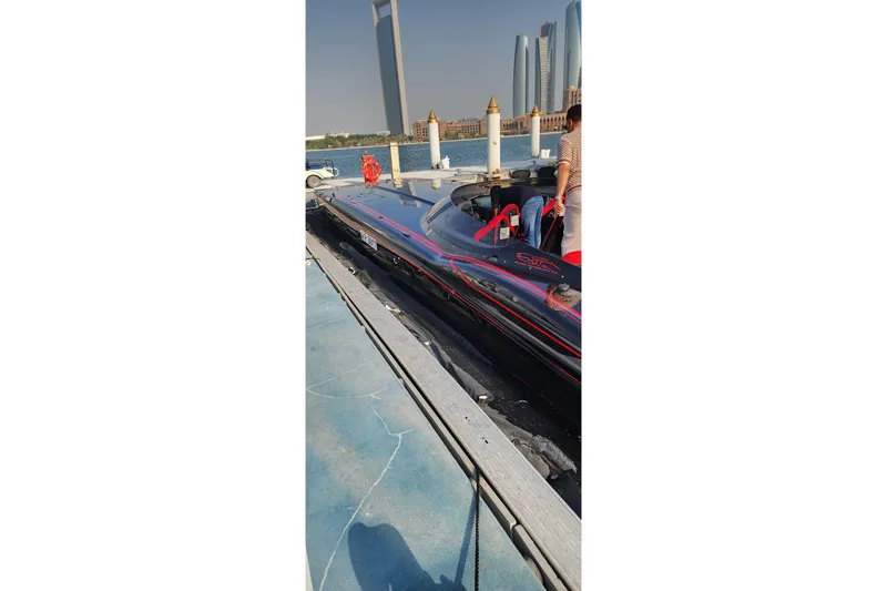  Yacht Photos Pics Sleek MTI 440X speedboat docked, 2025 model, with city skyline in the background.