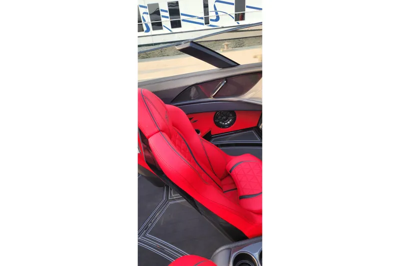  Yacht Photos Pics Red interior of 2025 MTI 440X boat with sleek design and speaker system.
