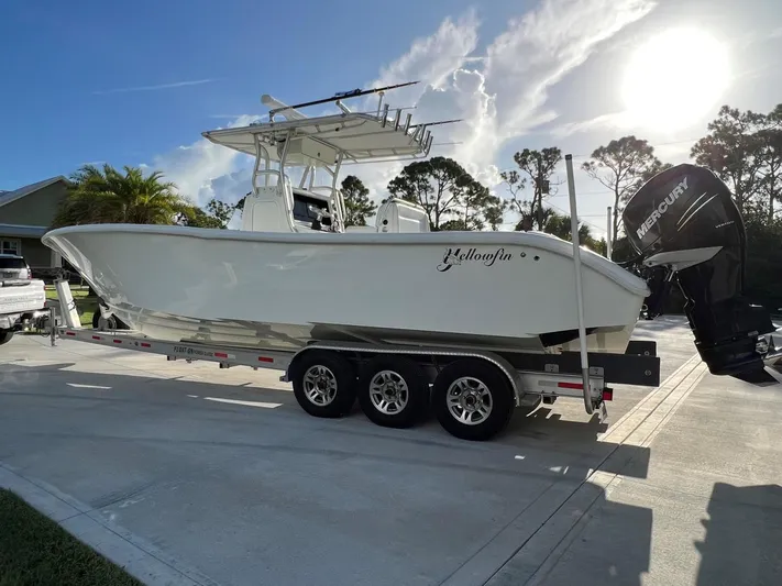 32 Yellowfin Yacht Photos Pics 2016 Yellowfin 32 Offshore boat on trailer, parked outdoors under a sunny sky.