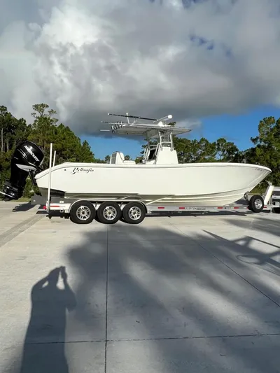 32 Yellowfin Yacht Photos Pics 2016 Yellowfin 32 Offshore boat on trailer under cloudy sky.