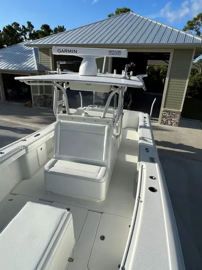 32 Yellowfin Yacht Photos Pics 2016 Yellowfin 32 Offshore boat with Garmin equipment, parked near a garage.