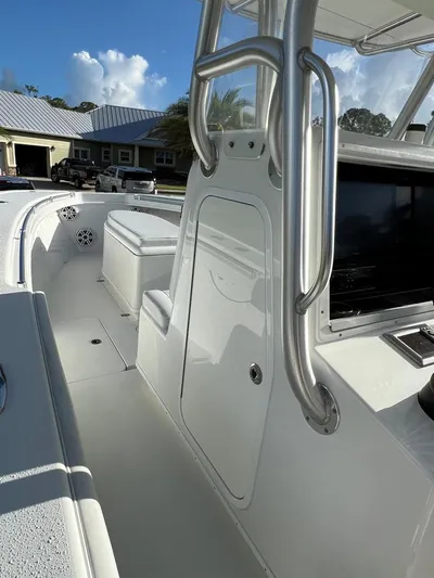 32 Yellowfin Yacht Photos Pics 2016 Yellowfin 32 Offshore boat interior with console and seating, under clear blue sky.