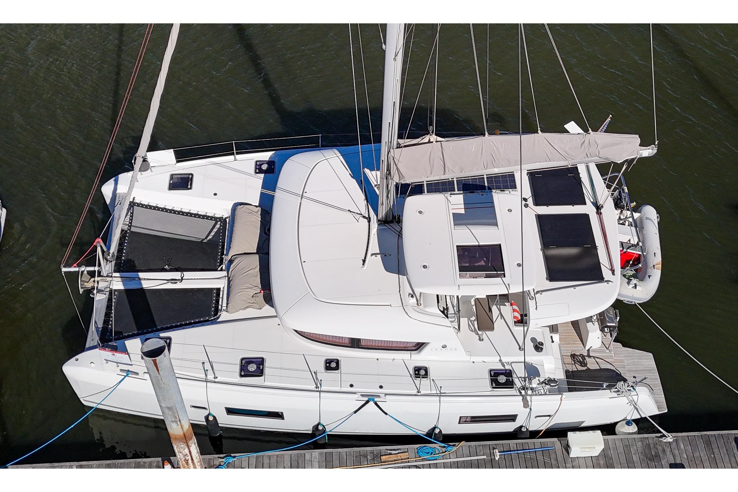 2017 Lagoon 42 Owners Version catamaran docked, aerial view showcasing deck and solar panels.