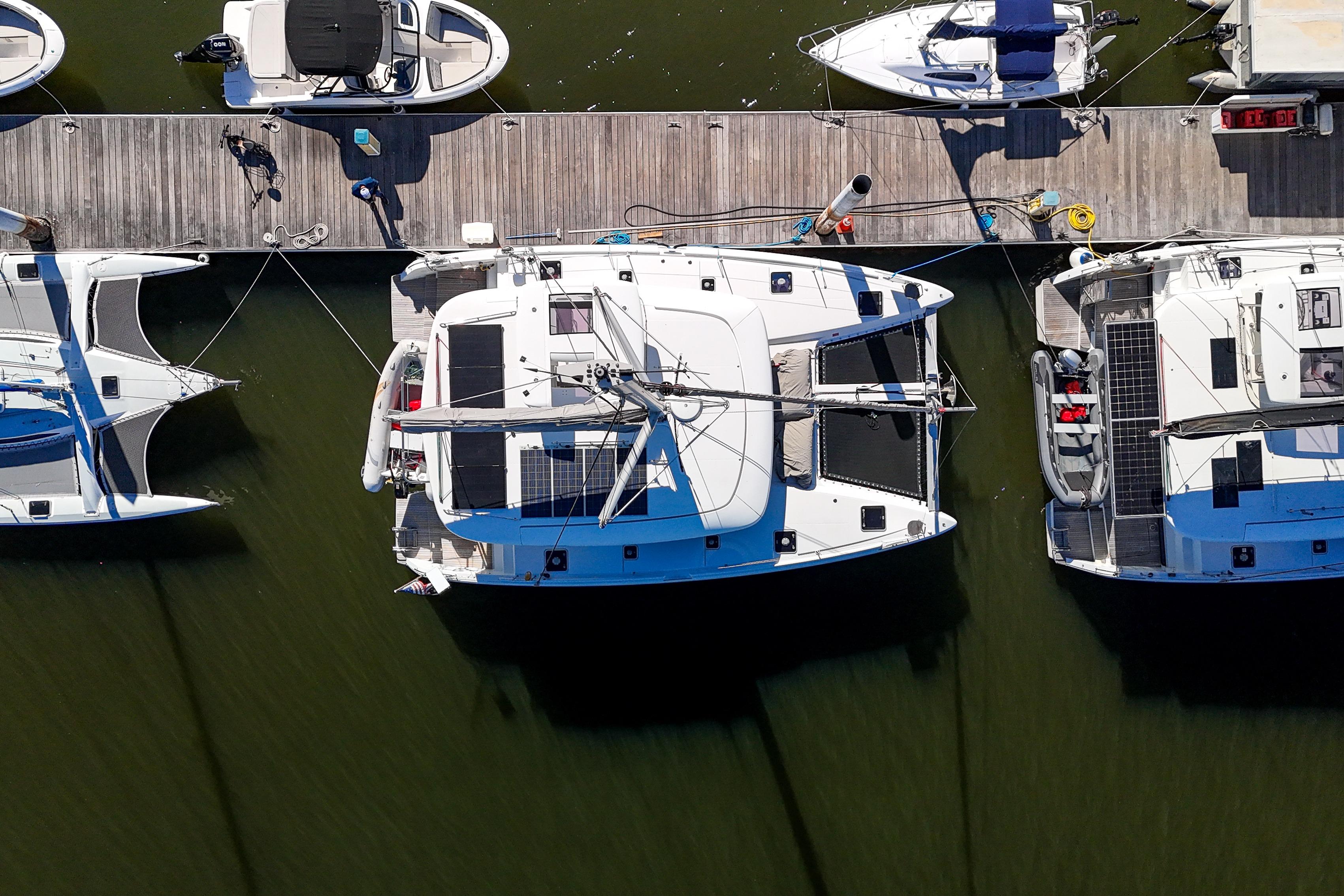 Overhead view of 2017 Lagoon 42 Owners Version catamaran docked at marina.
