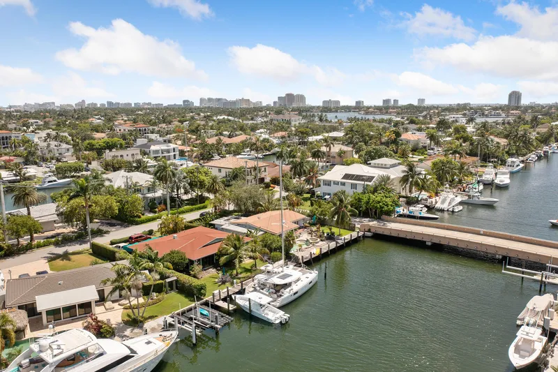 Curvy Mermaid Yacht Photos Pics Aerial view of a marina with a 2017 Lagoon 42 catamaran docked, surrounded by waterfront homes.